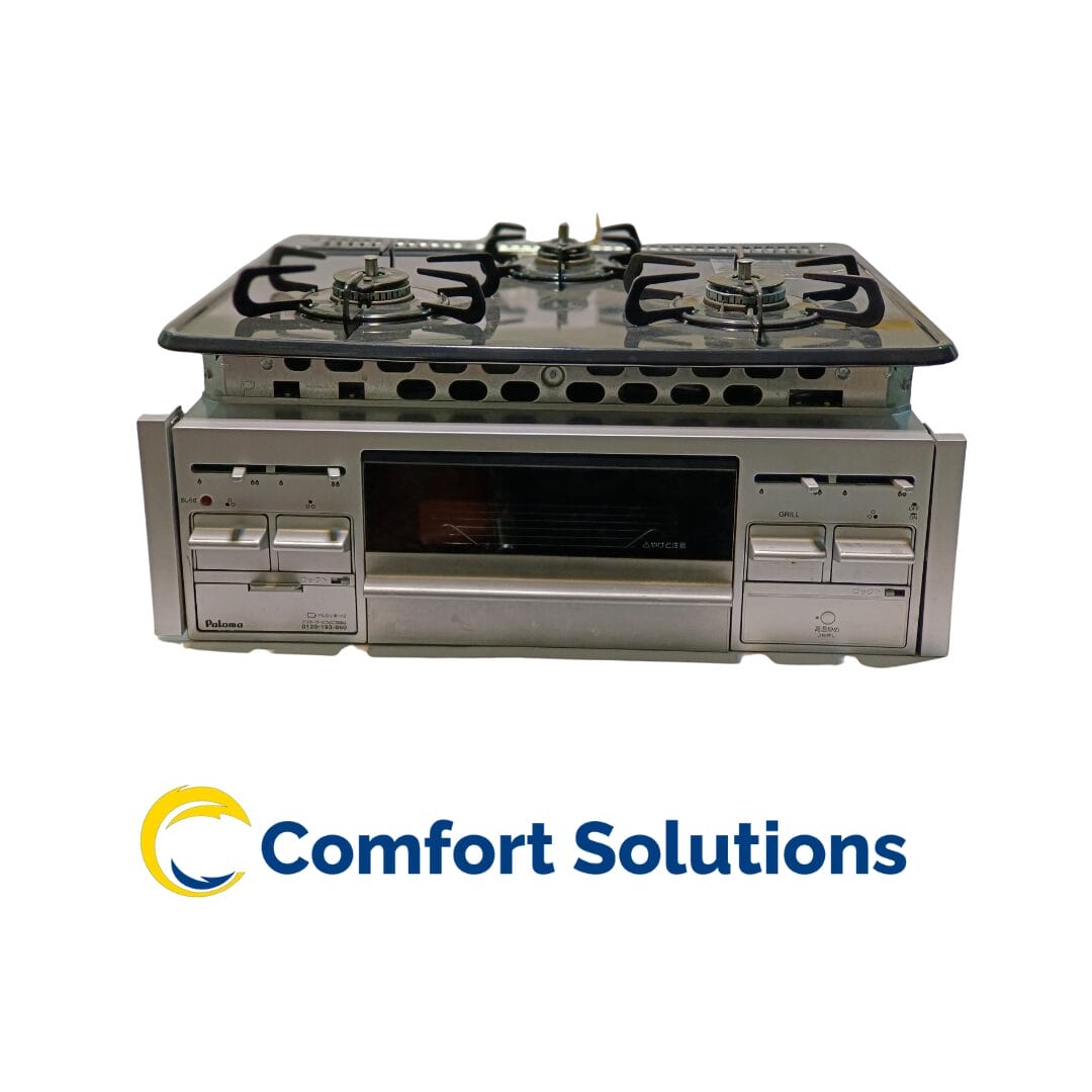 A silver paloma gas stove top with three burners sits above a matching oven. The stove features a glass top and a grill. The "Comfort Solutions" logo is at the bottom.